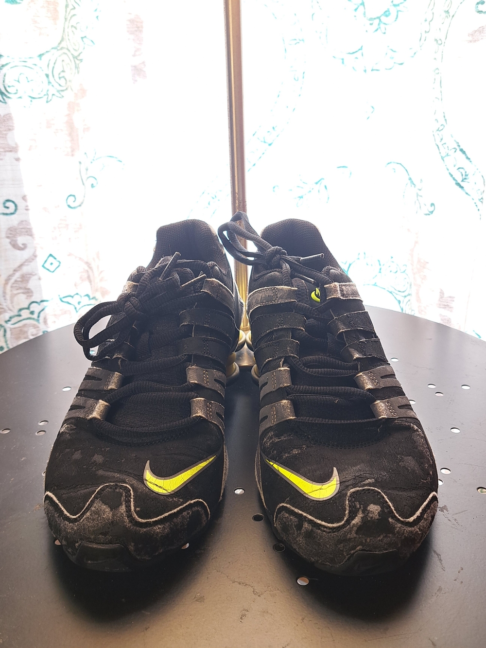 Black Nike Shox sneakers with neon yellow accents